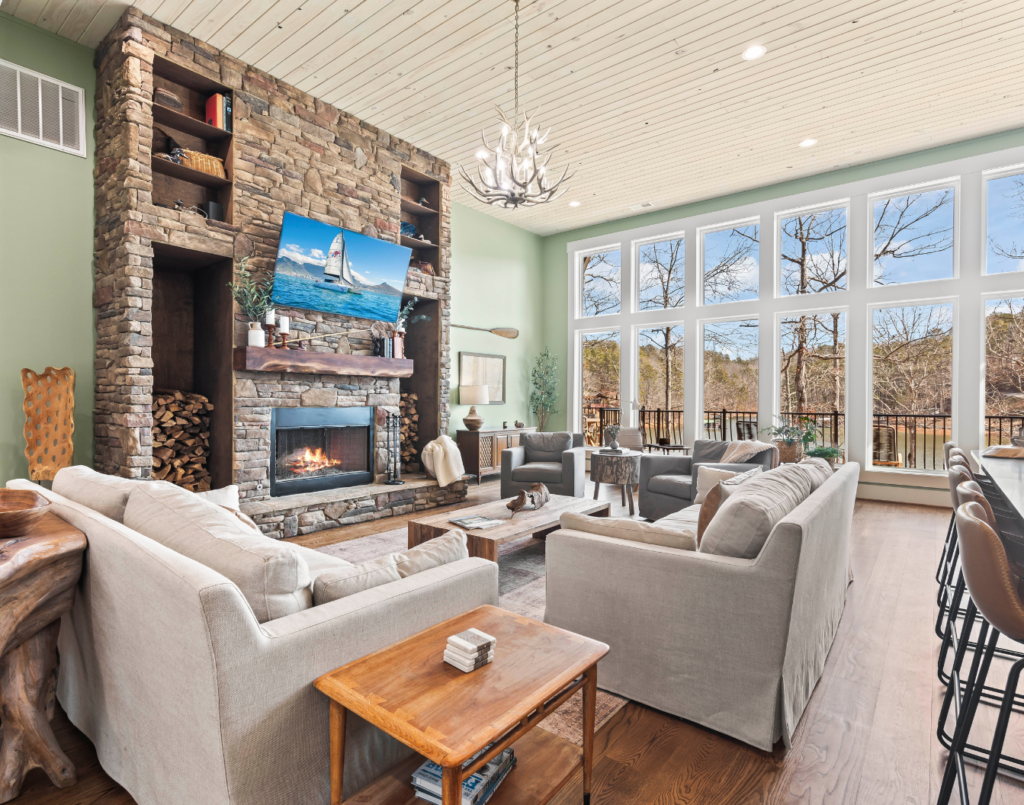 Bright luxury home interior with fireplace and large windows