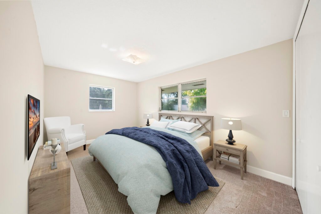 Bedroom with bed, blue bedding, and natural light