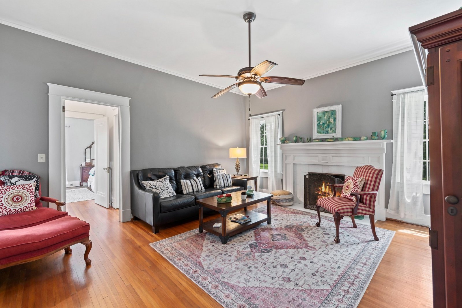 Professional interior real estate photograph featuring fireplace and living area